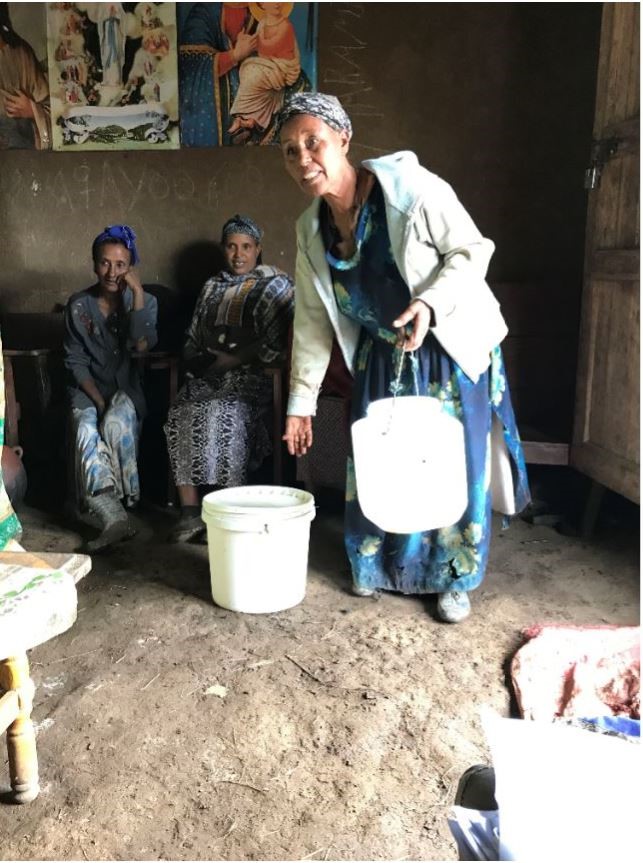 Women using paint bucket for milk container
